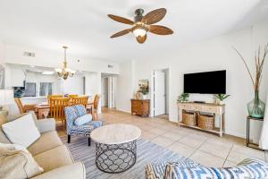 a living room with a couch and a tv at HP 124 Condo by 30A Escapes in Rosemary Beach