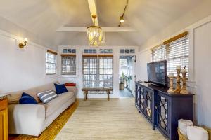 a living room with a couch and a tv at Fish, Hike & Unwind! Quiet Haven in Steinhatchee in Steinhatchee