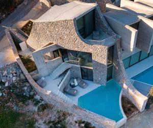 an aerial view of a building with a swimming pool at Mare e Pietra - Villa Mare in Pefkali
