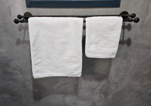 two towels hanging on a towel rack in a bathroom at Tarrentoela garden flatlet in Kathu +7 photos