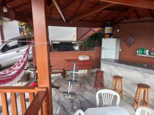 a kitchen with a table and chairs and a counter at Cantinho do Rosário in Diamantina +16 photos