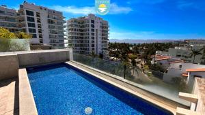 a swimming pool on the roof of a building at Terra 12 Penthouse Private Shallow Pool & Beach Access in Nuevo Vallarta