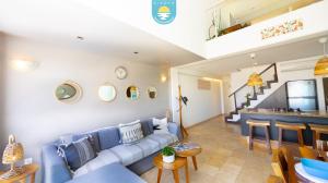 a living room with a blue couch and a table at Terra 12 Penthouse Private Shallow Pool & Beach Access in Nuevo Vallarta