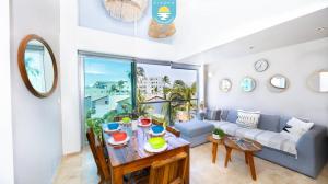 a living room with a couch and a table at Terra 12 Penthouse Private Shallow Pool & Beach Access in Nuevo Vallarta