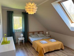 a bedroom with a bed with two towels on it at Dom w Sąpach in Sąpy