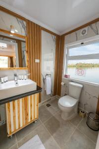a bathroom with a toilet and a sink and a window at Crociera sul Nilo Luxury in Luxor +59 photos