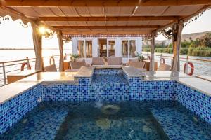 a pool in a house with a blue tiled swimming pool at Crociera sul Nilo Luxury in Luxor