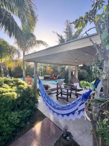 a hammock on a patio under a pavilion at Casa en Chuy in Chuy