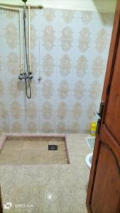a bathroom with a shower with a toilet and a sink at شقق دبي مفروشة in Tarfaya +6 photos