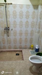 a bathroom with a shower and a toilet at شقق دبي مفروشة in Tarfaya