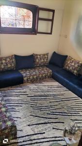a living room with a couch and a rug at شقق دبي مفروشة in Tarfaya
