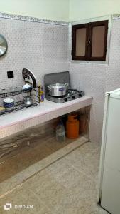 a kitchen with a stove and a counter top at شقق دبي مفروشة in Tarfaya