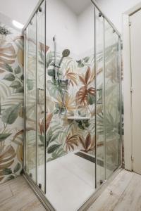 a glass elevator in a room with a floral wallpaper at Catherine's Home Central Apartment in Taormina +41 photos