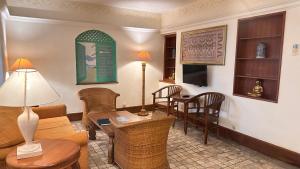 a living room with a couch and a table and chairs at Nattaya at the Jayakarta Bali in Seminyak