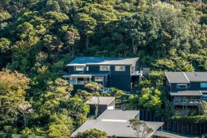 an aerial view of houses in a forest at Miro Ridge in Palm Beach in Waiheke Island