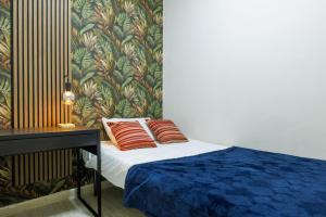 a bedroom with a bed with two red pillows at Catherine's Home Central Apartment in Taormina