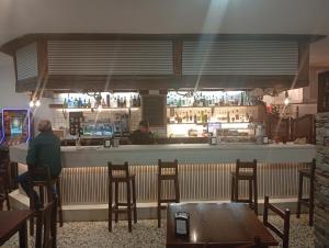 a man sitting at a bar in a restaurant at A taberna de vento in Lalín +21 photos