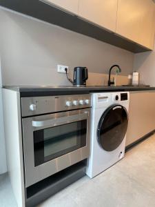 a kitchen with a stove and a washing machine at Große Wohnung in Graz SOVA 1 in Graz +10 photos