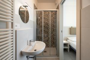a bathroom with a sink and a shower at Sumus Smart Residence in Porto SantʼElpidio +71 photos