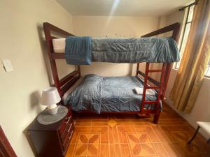 a room with two bunk beds and a lamp at El refugio de Lolita in Loja