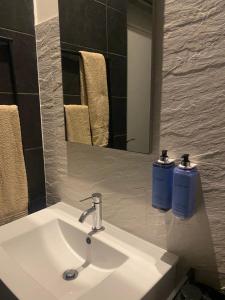 a bathroom sink with two soap bottles on it at Casa da Âncora in Viana do Castelo +26 photos