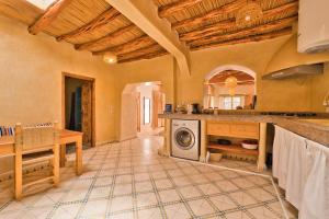 a kitchen with a washing machine and a table at Villa Nouran Beldi in Essaouira +17 photos