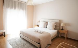 a bedroom with a bed with two candles on it at S. Mamede House - Penafiel in Recezinhos +54 photos