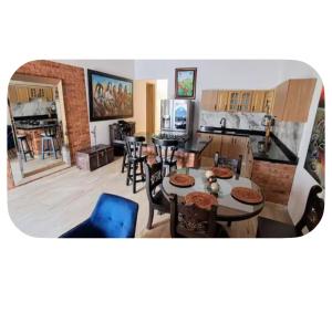 a kitchen and living room with tables and chairs at Casa totalmente amoblada in Yopal
