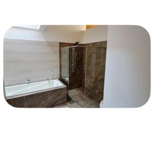 a bathroom with a bath tub and a shower with a glass door at Casa totalmente amoblada in Yopal +3 photos