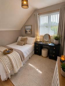 a bedroom with a bed and a dresser and a window at The Acres Retreat -Cosy and Welcoming in Lisnaskea