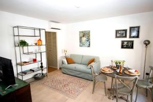 a living room with a couch and a table at Cap SOLEIL in Antibes