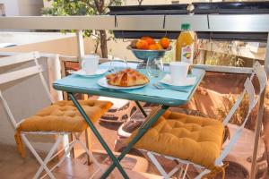 a table with a plate of food and a bowl of fruit at Cap SOLEIL in Antibes