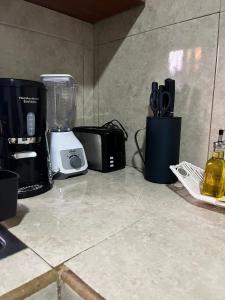a counter with a blender and other appliances on it at Casa Isabella 45 AC en las habitaciones in Matagalpa