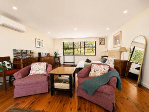a living room with two chairs and a table at Narrow Neck Views - Peaceful 4 Bedroom Home with Stunning Views! in Katoomba