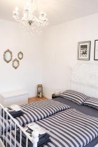 a bedroom with a bed and a chandelier at ILA vacation home Memmingen in Memmingen