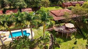 an aerial view of a house with a pool and palm trees at Pousada Caruaru in Socorro