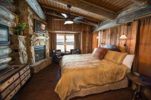 a bedroom with a large bed and a fireplace at Zion Mountain Ranch in Mount Carmel Junction