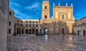 a large building with a tower and a church at Elysia Luxury Room con Jacuzzi - Centro Brindisi in Brindisi