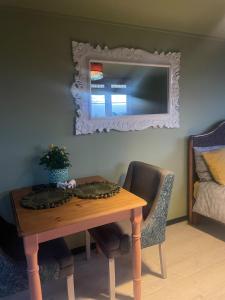 a dining room table with a mirror on the wall at Digital detox unplugged retreat in Southam
