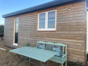 a picnic table in front of a log cabin at Digital detox unplugged retreat in Southam