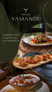a restaurant with two plates of food on a table at Pousada Yamandu - SPA Aquecido in Juquei