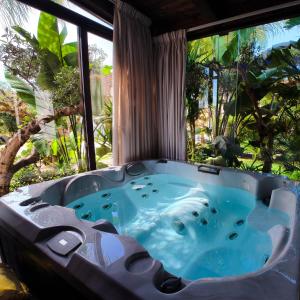a jacuzzi tub in a room with a window at Villa Margot in Agropoli