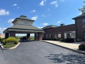 a building with a parking lot in front of it at South Branch Inn Romney in Romney