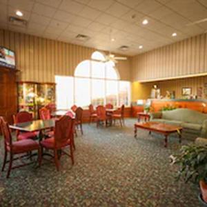 a restaurant with tables and chairs and a couch at South Branch Inn Romney in Romney