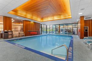 a large swimming pool in a building with a ceiling at Best Western PLUS The Arden Park Hotel in Stratford