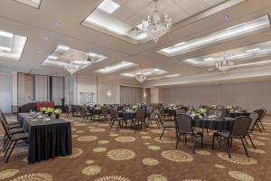 a banquet room with tables and chairs and chandeliers at Best Western PLUS The Arden Park Hotel in Stratford +64 photos