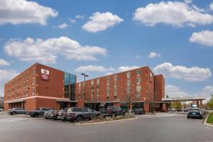 a building with cars parked in a parking lot at Best Western PLUS The Arden Park Hotel in Stratford
