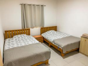 two twin beds in a room with a window at Lake of Diber in Debar
