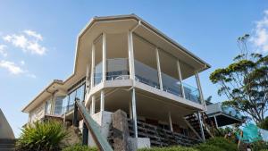 a house with large windows on the side of it at Azure Vista in Belmont