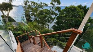 a balcony with a view of the water at Azure Vista in Belmont